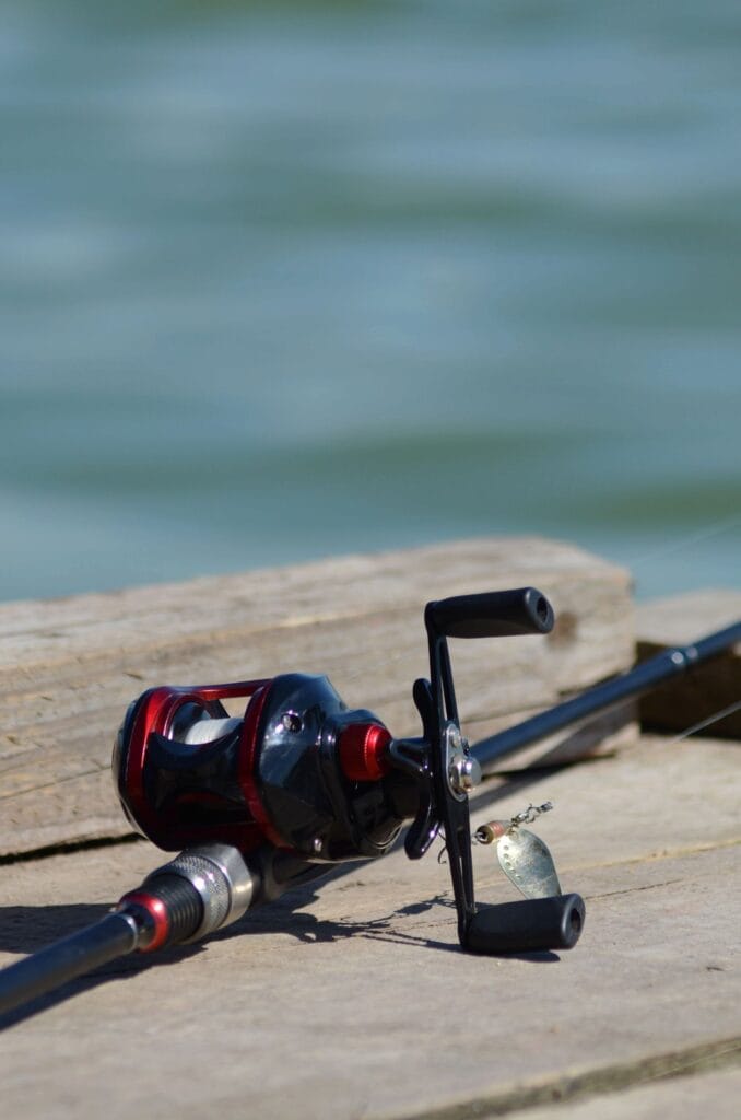 Fishing rod on a wooden dock by the water