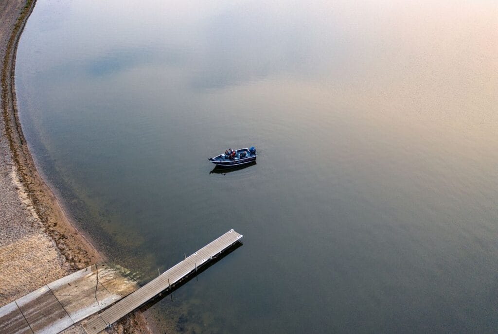 Aerial view of a boat fishing a lake