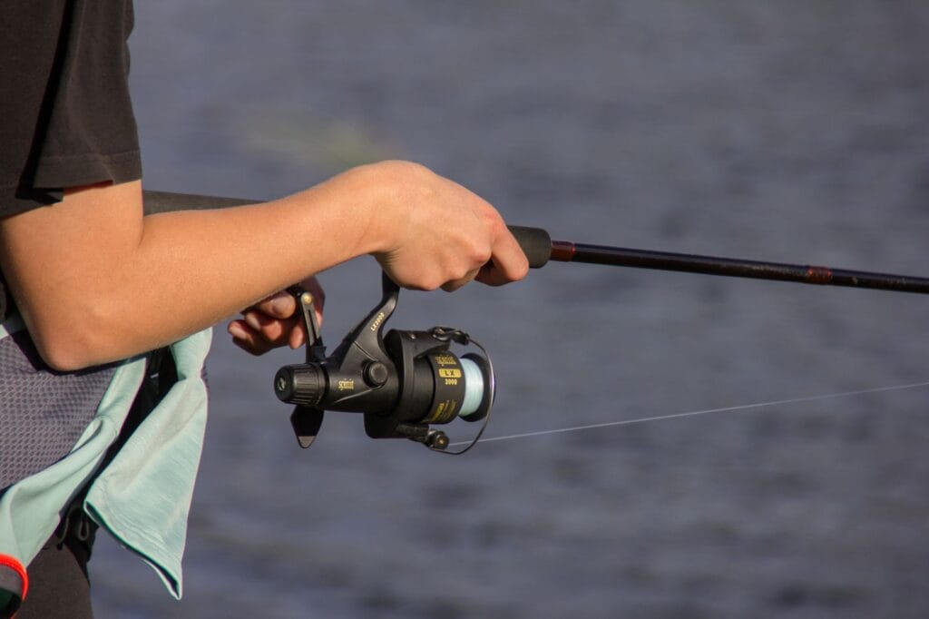 Angler fishing a pressured summer lake