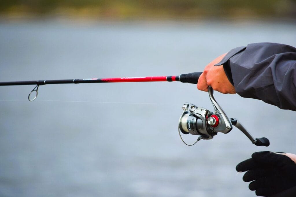 Angler fishing a river with a rod and reel