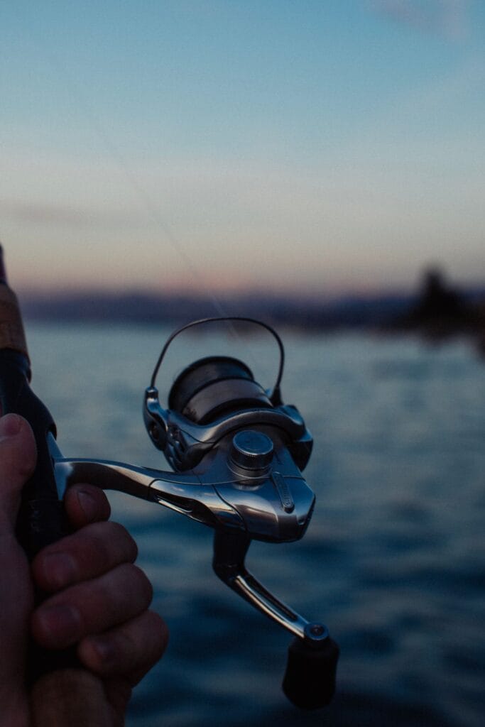 Fishing rod over a calm lake at dawn